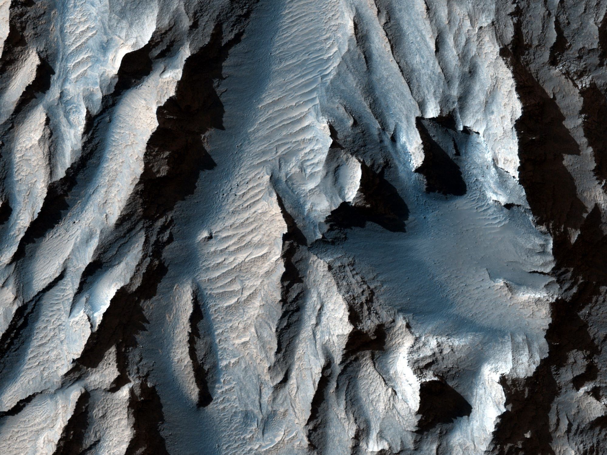 NASA says the new images reveal a huge valley on the surface of Mars, the largest in the solar system