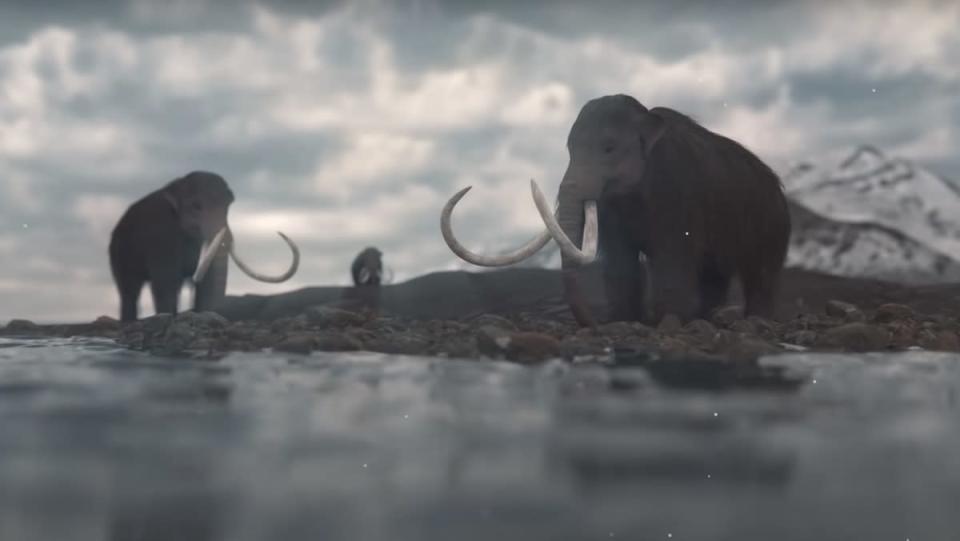 Imagem de três mamutes peludos perto da água, não muito longe de um iceberg