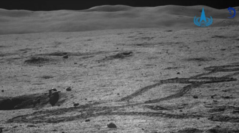 snaking rover tracks in the gray dirt of the moon.