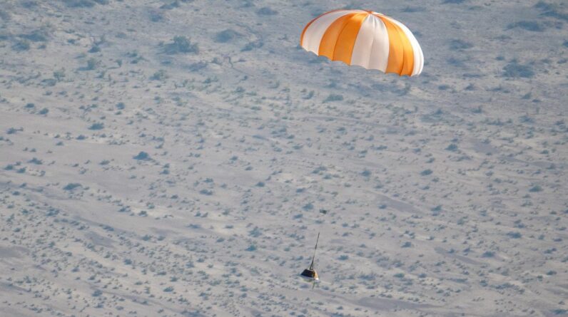 a sample space capsule parachuting to Earth in a test