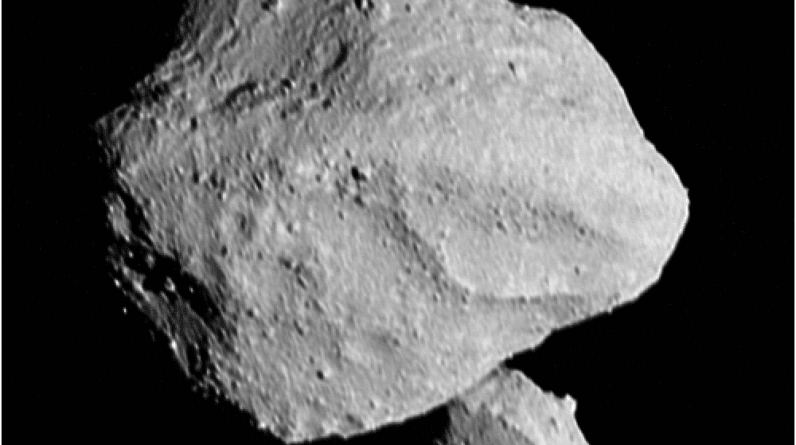 An image of asteroid Dinkinesh, a pair of grey asteroids with a slightly jagged surface, taken from the Lucy spacecraft.