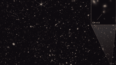 A very starry and galactic section of deep space. A box on the top-right shows an enlarged view of one of the galaxies.
